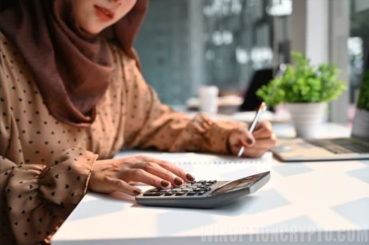 Muslim woman doing calculations